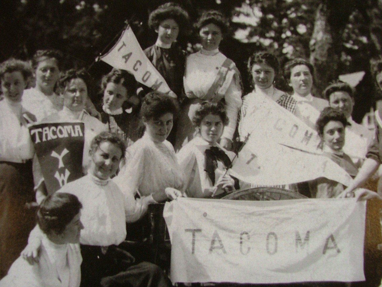 Women from 1906 charter of YWCA in Tacoma holding YWCA banners